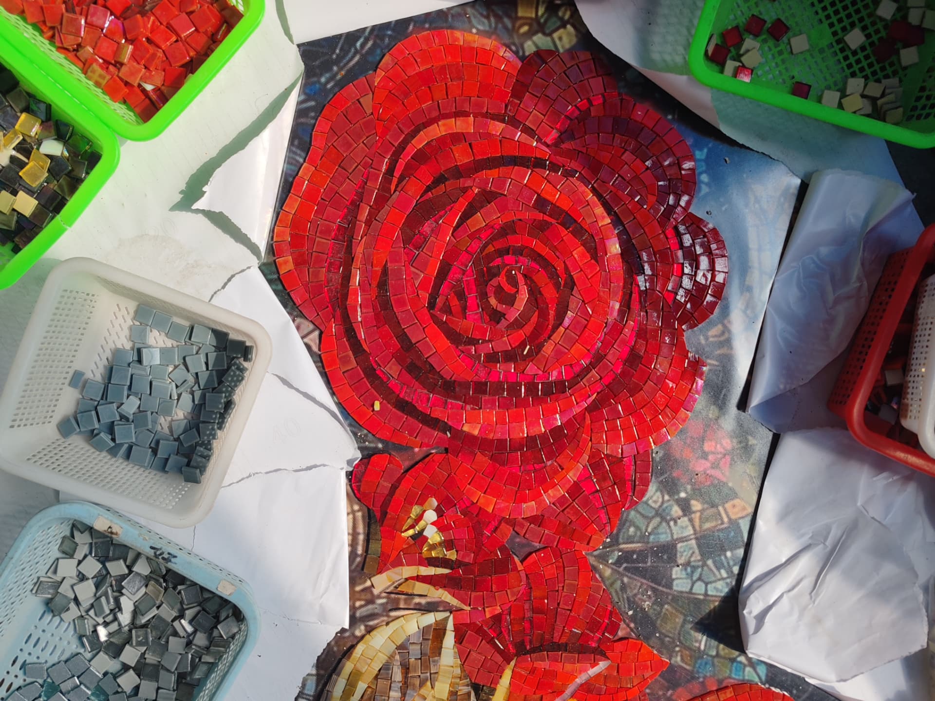 Close-up of the hand-cut red glass rose in progress