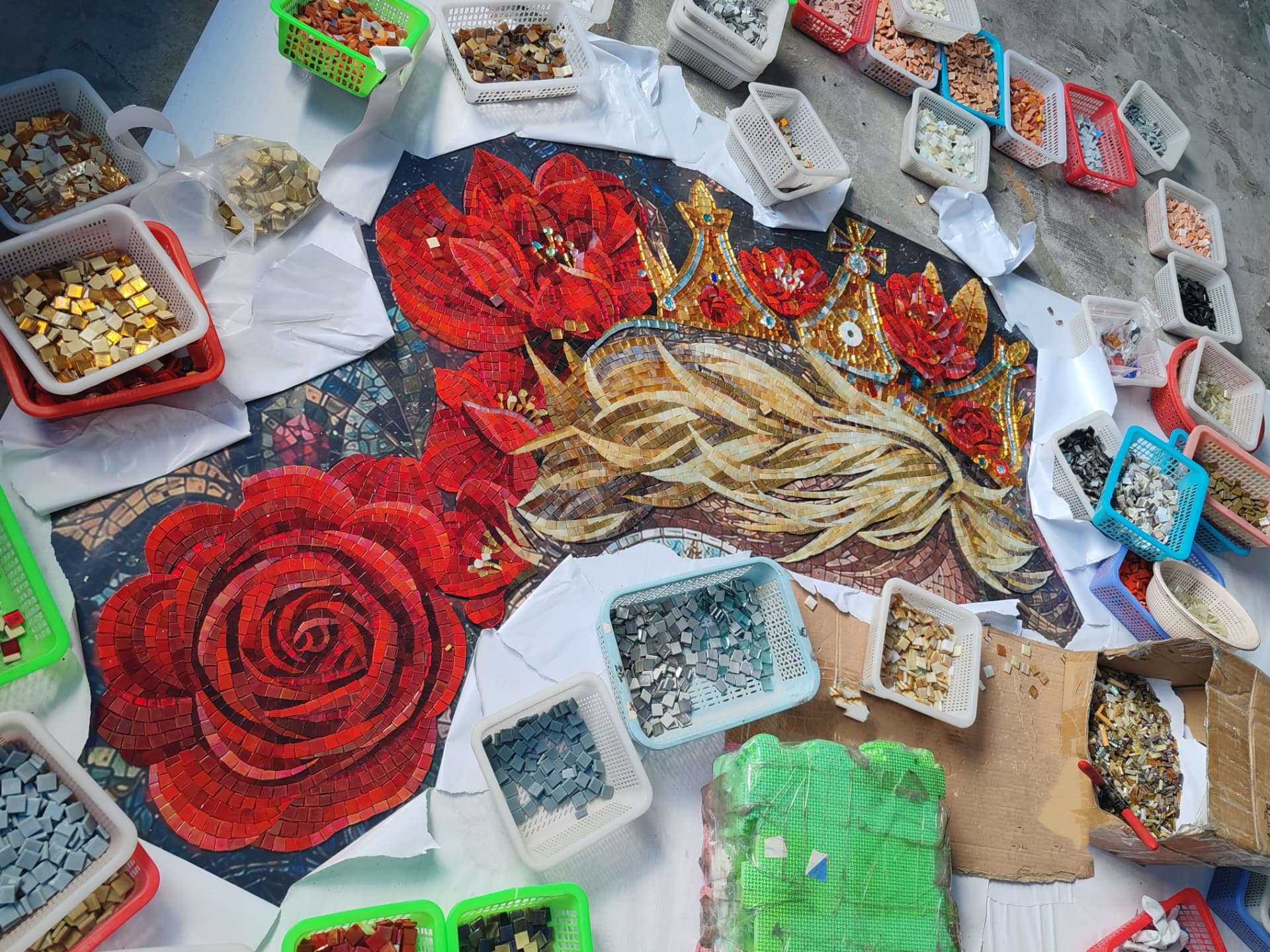 The rose, lilies and crown section laid out in the studio